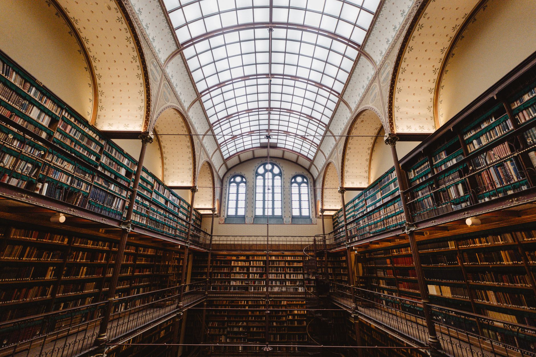 Stunning interior view of a historic library showcasing vast book collections in Amsterdam.